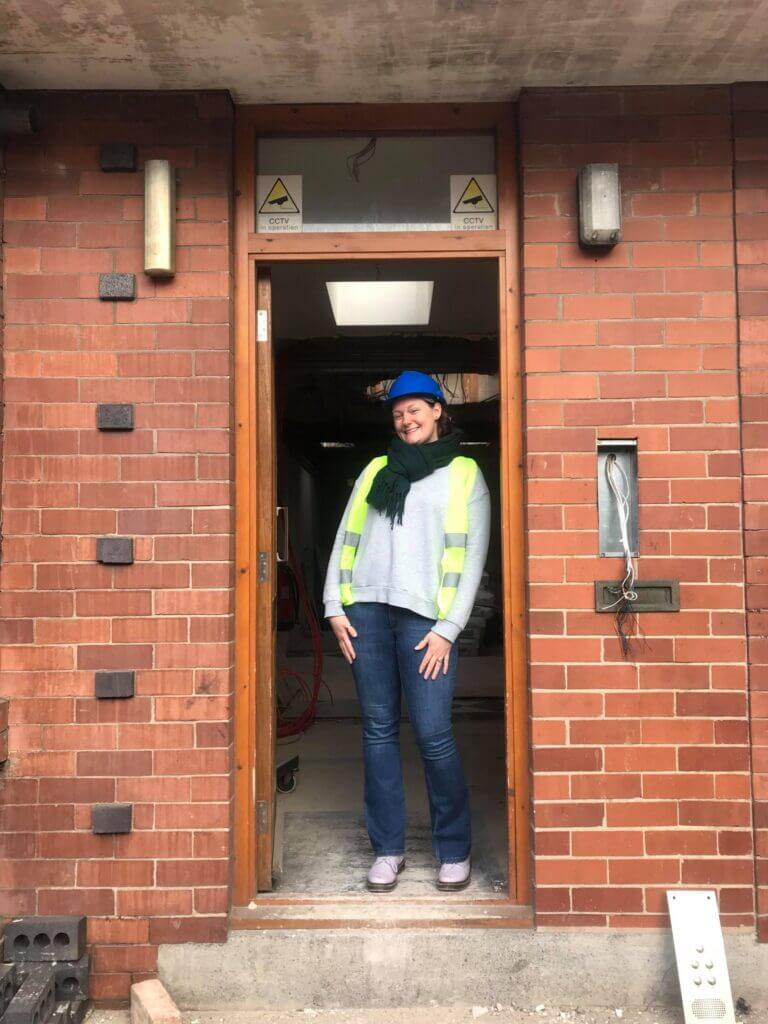 Rhian Aitken, Art Hostel Manager stands outside the hostel